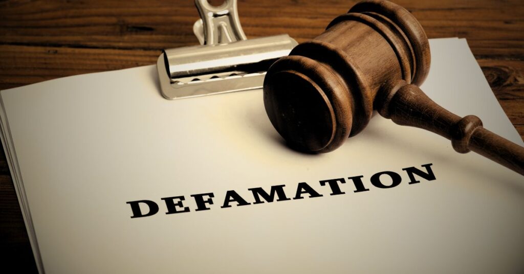 Document labeled defamation on a desk with a judge’s gavel placed on top.