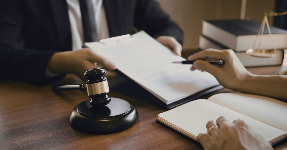 Attorney reviewing an insurance policy with a client during a property claim consultation.