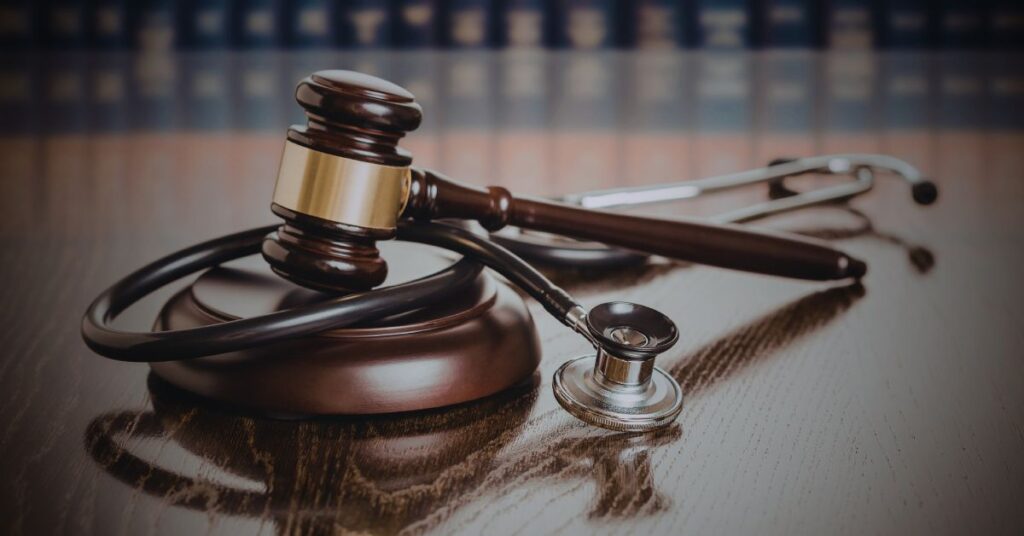Judge’s gavel and stethoscope on a desk symbolizing medical malpractice litigation.
