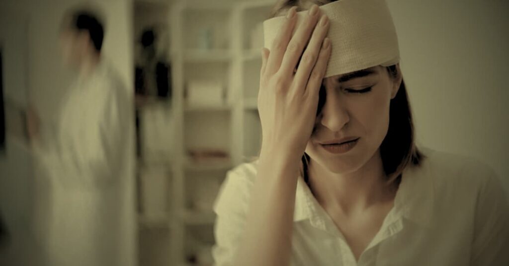 Woman with head bandage after traumatic brain injury seeking legal help