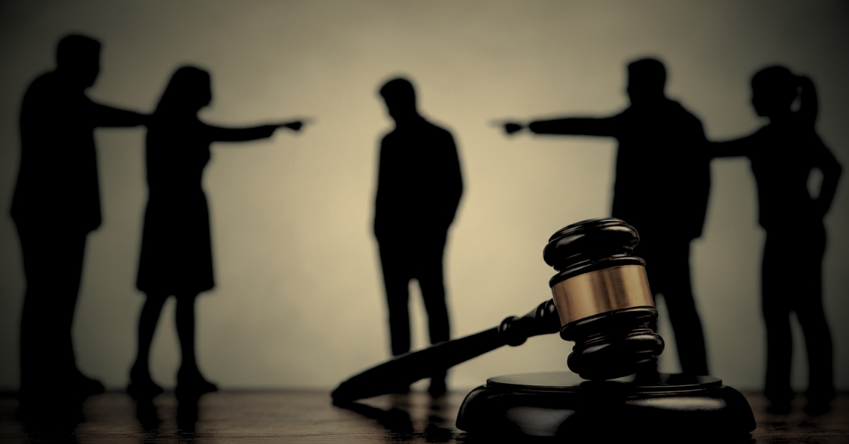 Defamation of character Florida — silhouettes pointing fingers with gavel representing false accusations